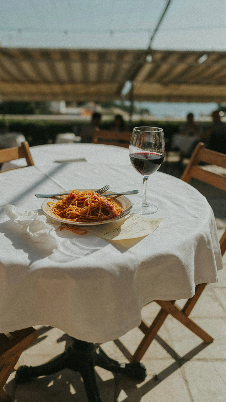 An outdoor dining table shows signs of guests leaving early.