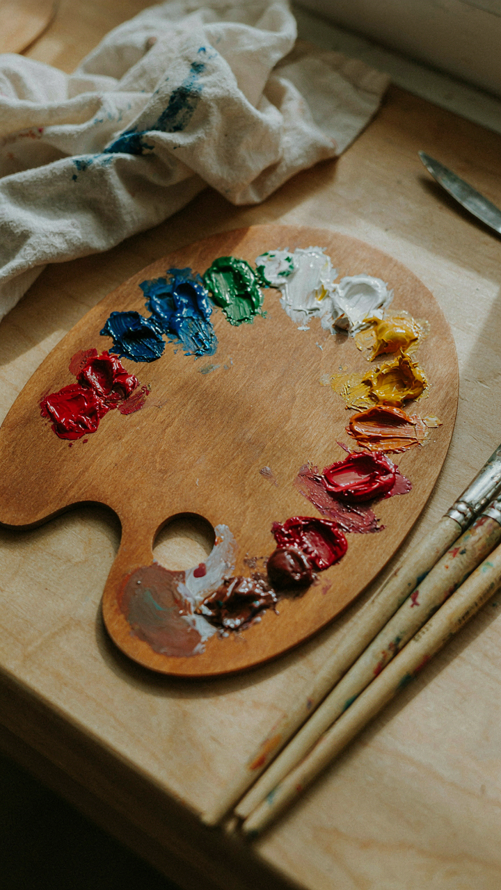 A painter's palette holds many contrasting and vibrant colors.