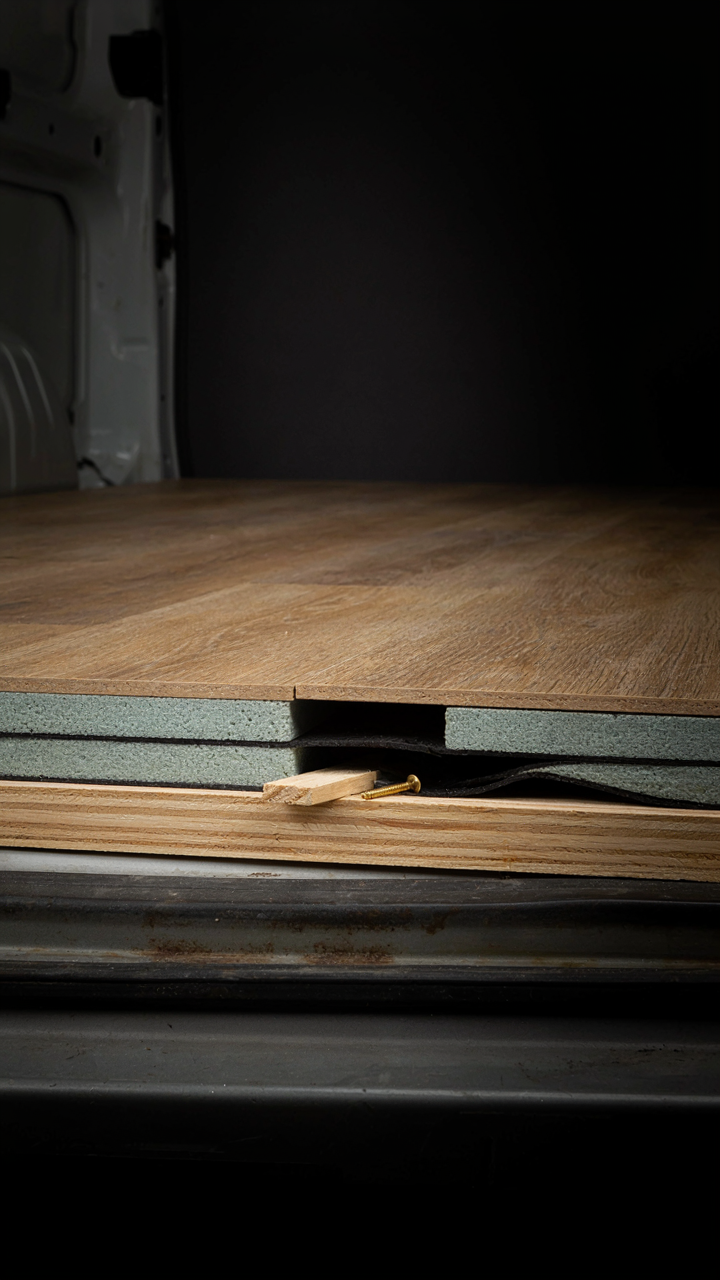 A cross-section view of a van floor with insulation layers.