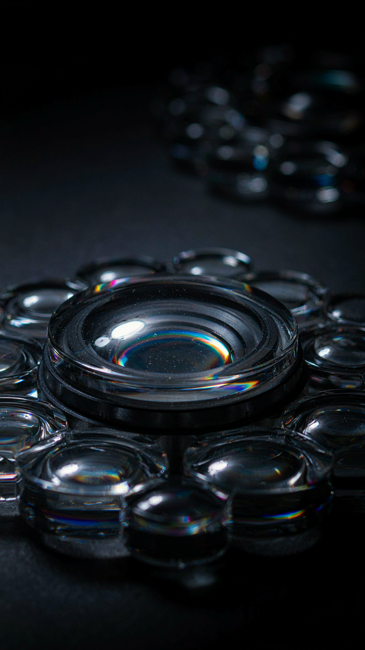 A complex array of optical lenses focuses and reflects light.