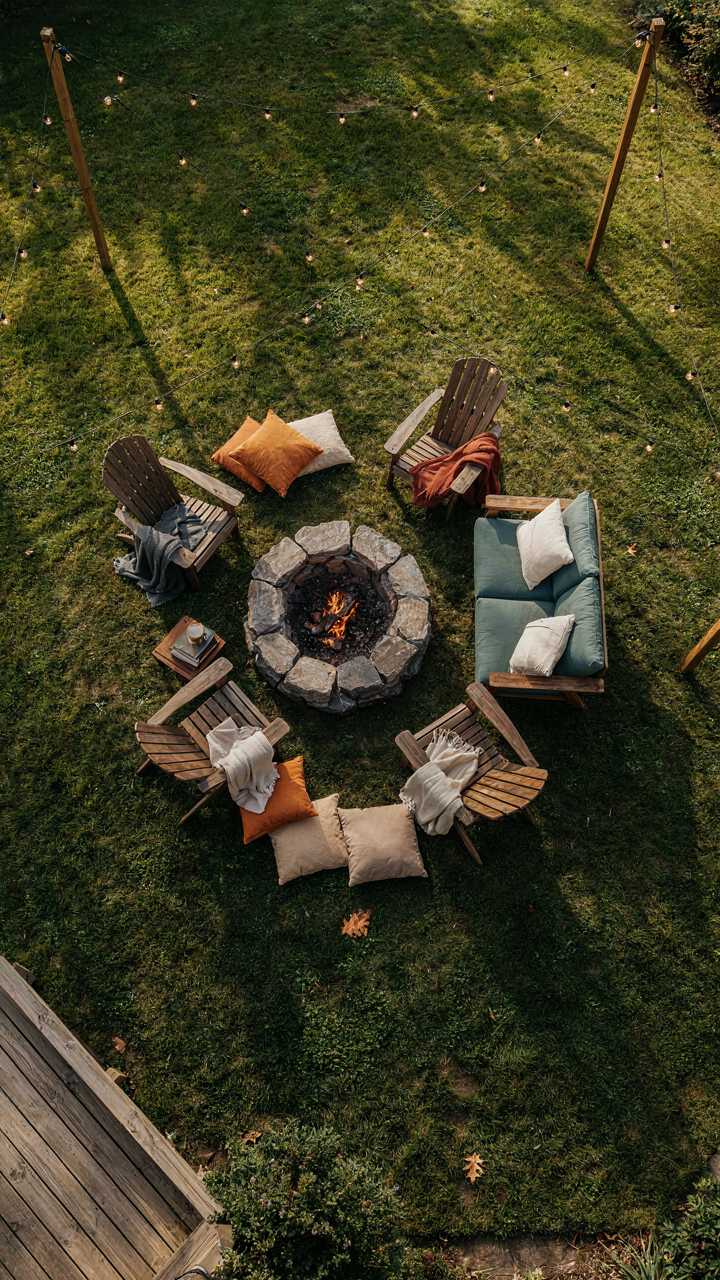 An aerial view of a backyard fire pit party setup with diverse seating.