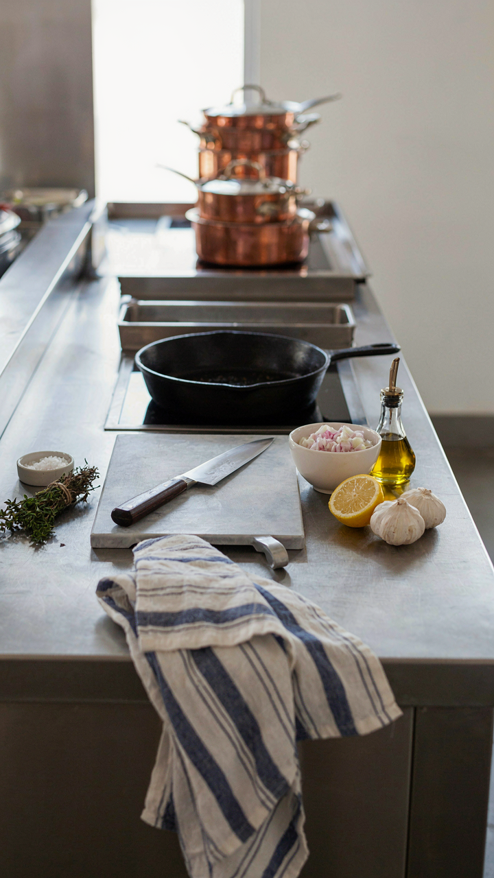 A professional kitchen station is neatly organized with prepped food.