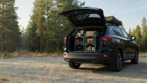 A comprehensive camping crate system organized in the trunk of an SUV, ready for travel.