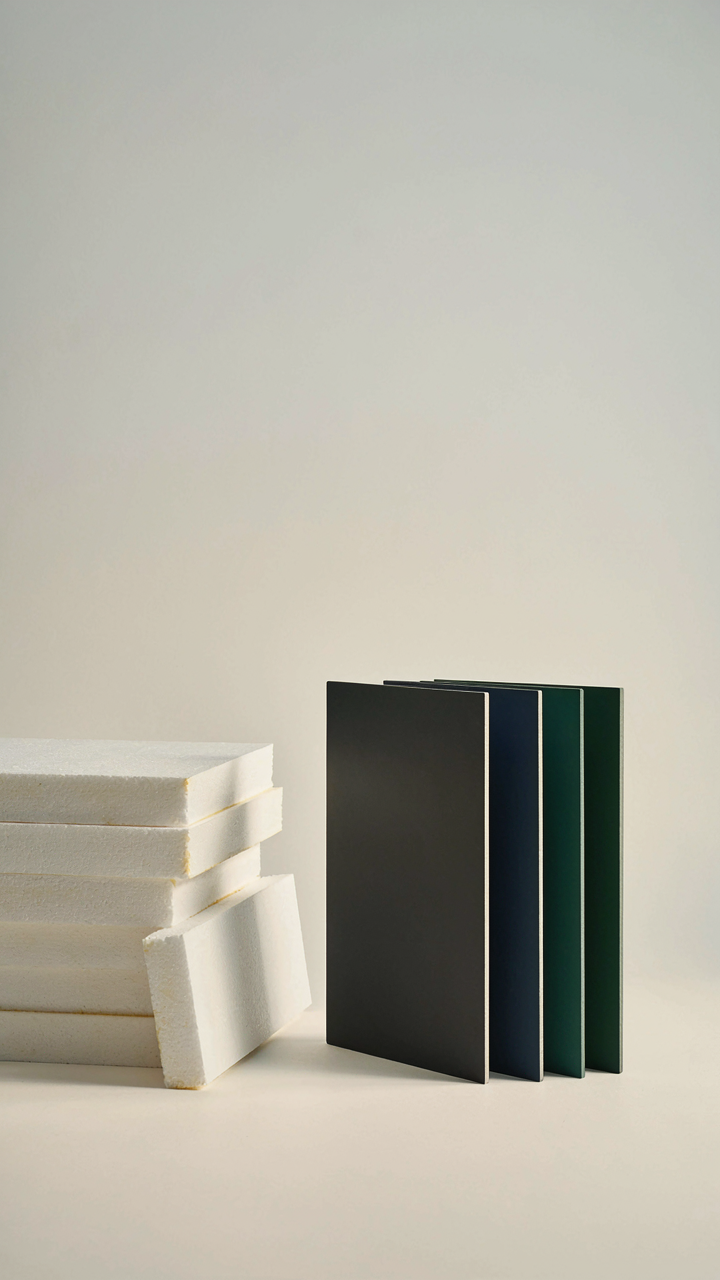 A stack of cheap foam boards sits next to expensive branded panels.