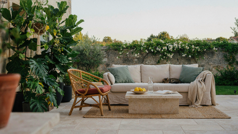 An inviting outdoor patio with comfortable furniture and warm lighting. It is cozy patio decor.