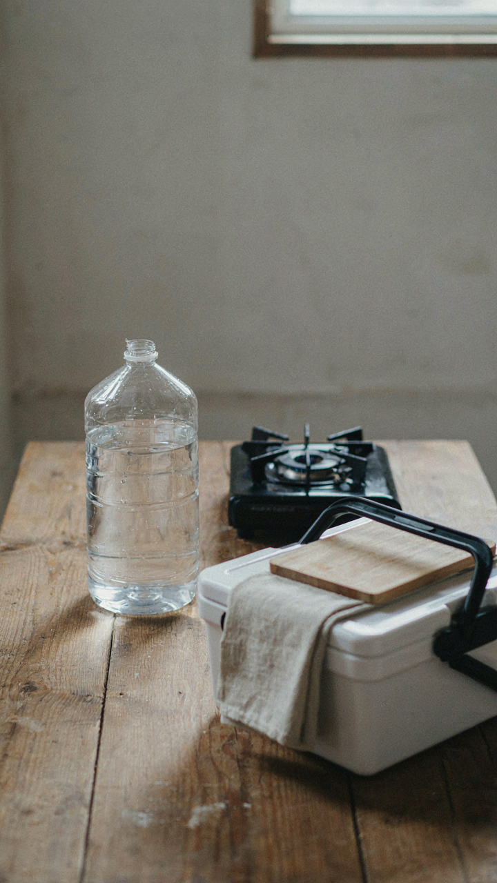 Three separate, essential parts of a diy camper kitchen sit on a table.