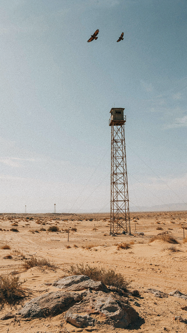 A military observation post overlooks a wide desert landscape.