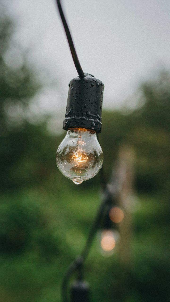 A durable, weather-resistant string light with water droplets on it.