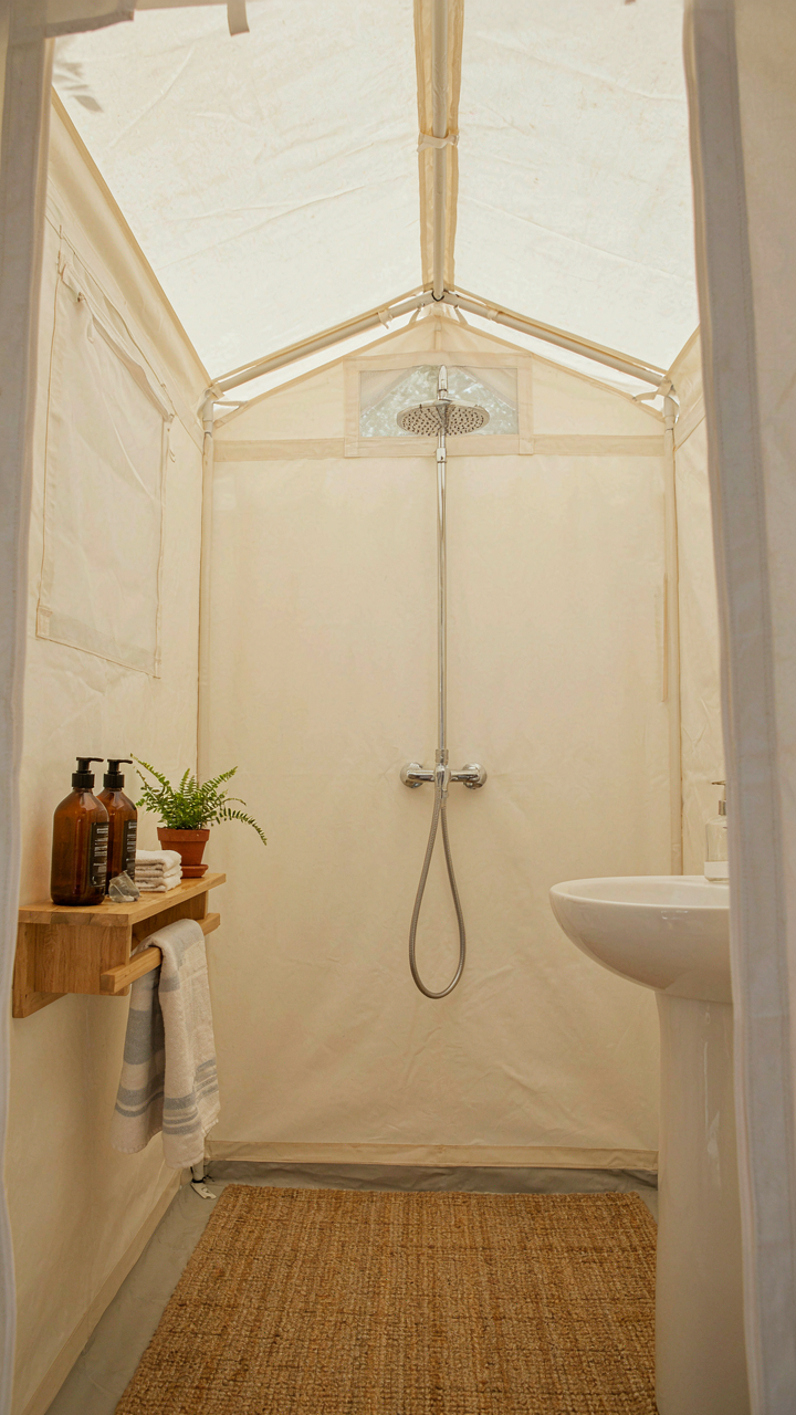 A spacious, well-designed interior of a DIY shower tent for comfort.