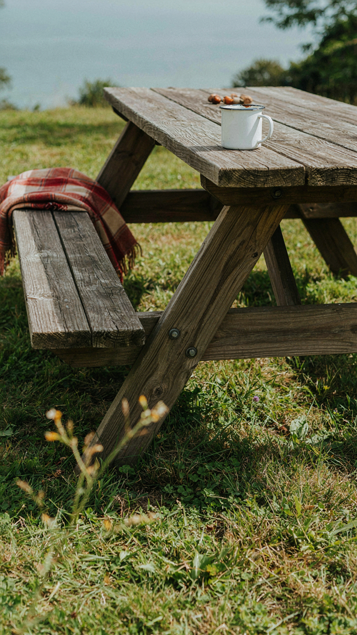 A sturdy, heavy-duty outdoor picnic table made from thick, weather-treated wood.