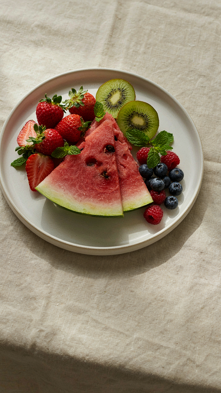 A fruit platter with watermelon slices and other fruits.