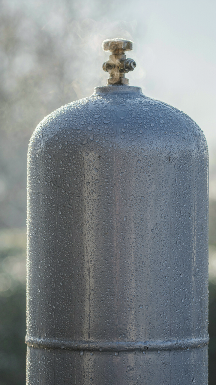 Condensation forms on the cold exterior of a propane tank.