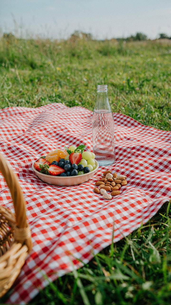 Healthy snacks like fruit, almonds, and water for a backyard campout.