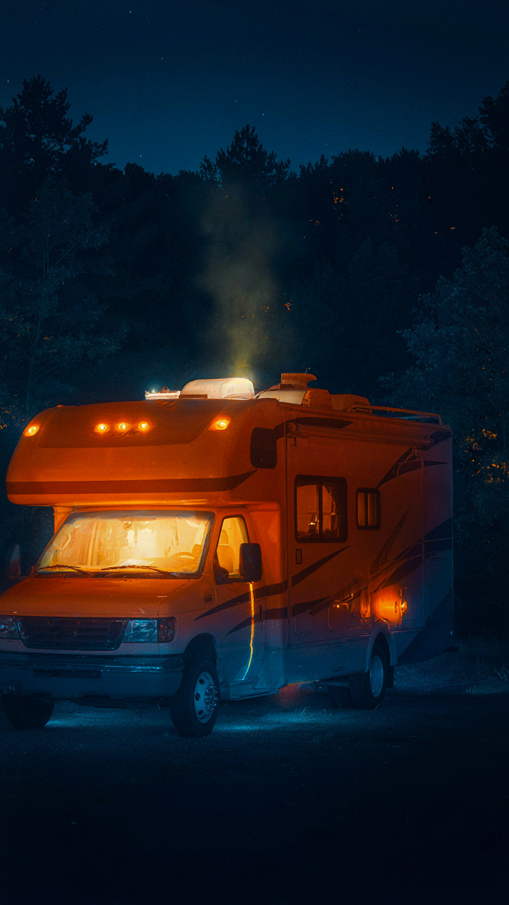A thermal camera shows heat escaping from an RV at night.