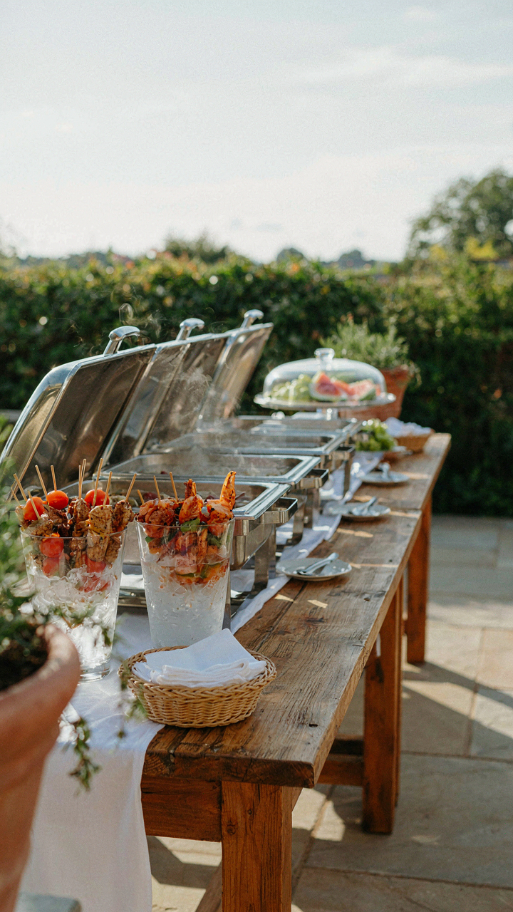 Outdoor serving station with ice and hot containers for food.