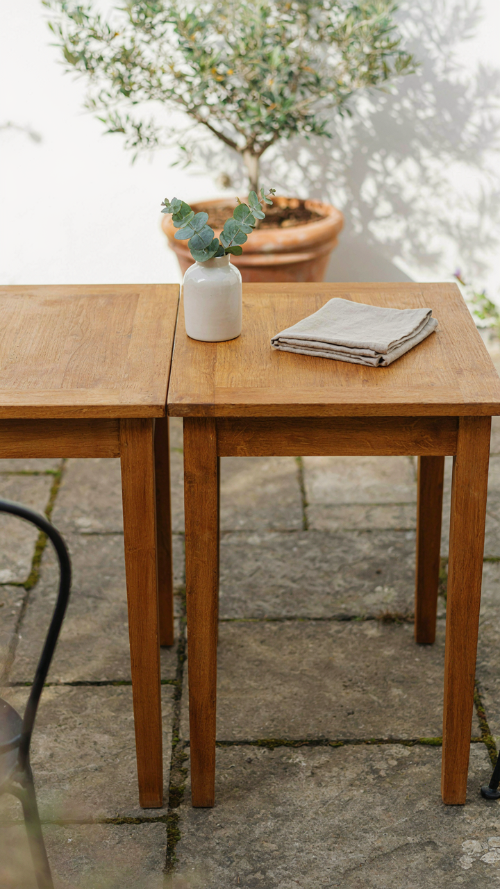 Two square tables joined to make a larger outdoor table.
