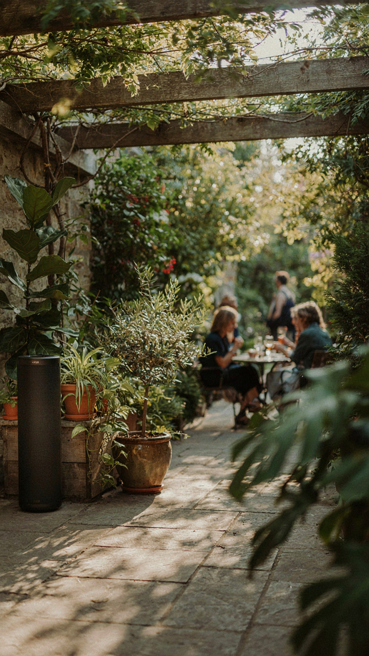 A small outdoor speaker hidden in plants plays soft music for a new years eve backyard party.