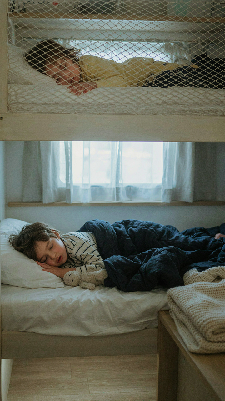 Two children sleep soundly in secure RV bunk beds.