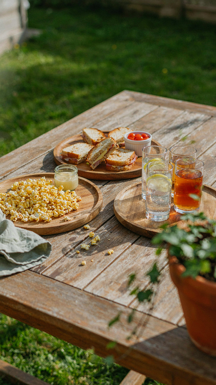 Individual serving trays hold contained snacks for a backyard movie night.