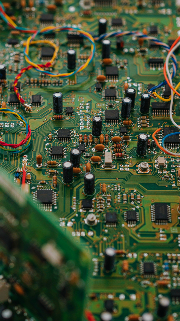 A complex electrical circuit board shows many wires and parts.