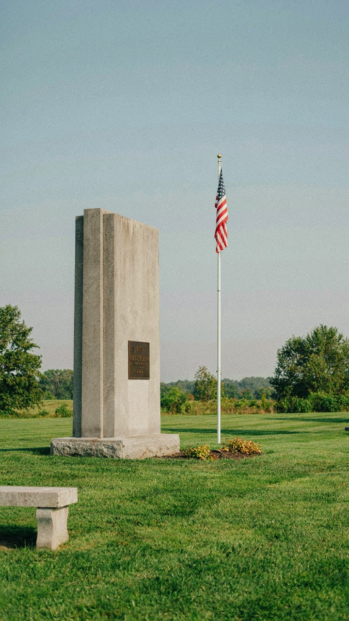 A quiet monument with an American flag honors soldiers.