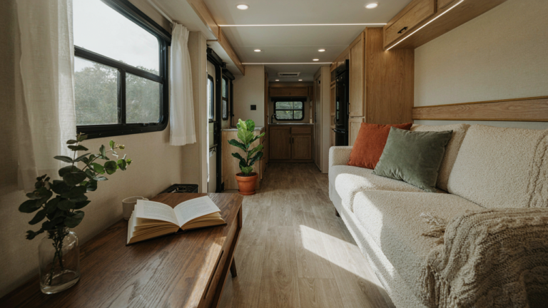 A modern and inviting RV interior with a freshly upholstered rv couch.