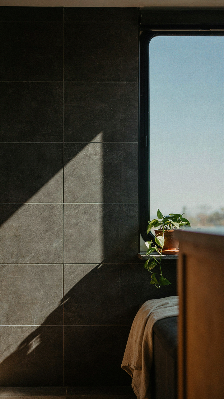 A sunny RV interior with dark tiles absorbing heat from a window.