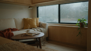 A warm and inviting RV living room on a rainy day, showing cozy rv living room ideas.
