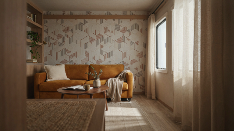 A modern RV interior with geometric wallpaper and bright sunlight coming through a window.