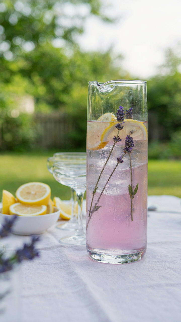 A large pitcher of lavender lemonade mocktail for a crowd.