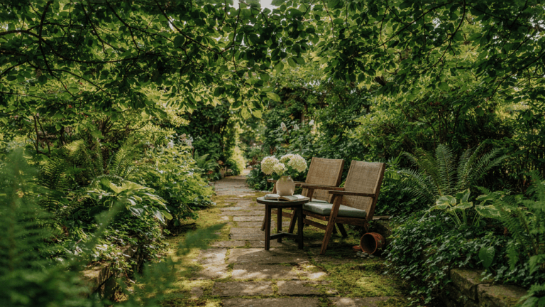 A serene shady garden retreat with a cozy chair under a canopy of green trees.