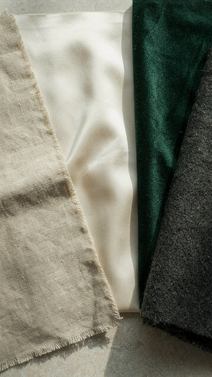 Close-up of different fabric textures including linen, silk, velvet, and wool.