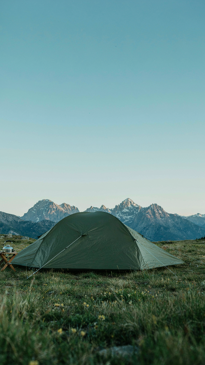 A perfectly tight tent stands with all its ropes secured.