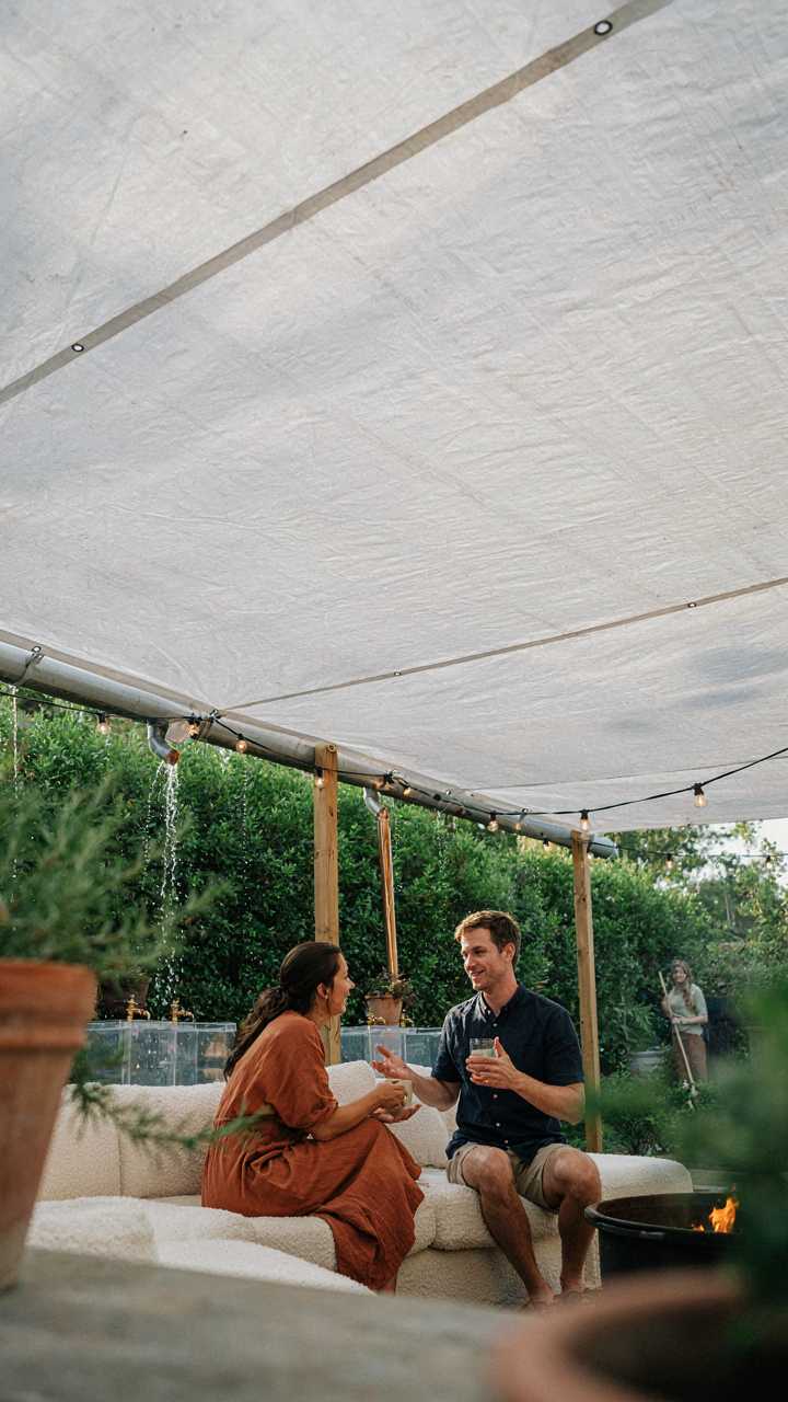 A creative system of tarps and gutters redirects rainwater away from a party area.