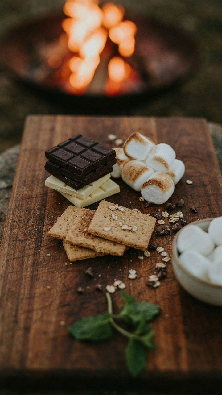 Gourmet s'mores ingredients arranged beautifully on a board for a fire pit party.