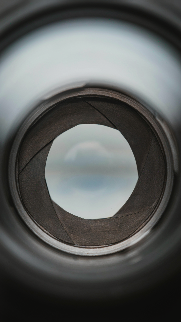 A camera aperture mechanism adjusting its opening in response to light.