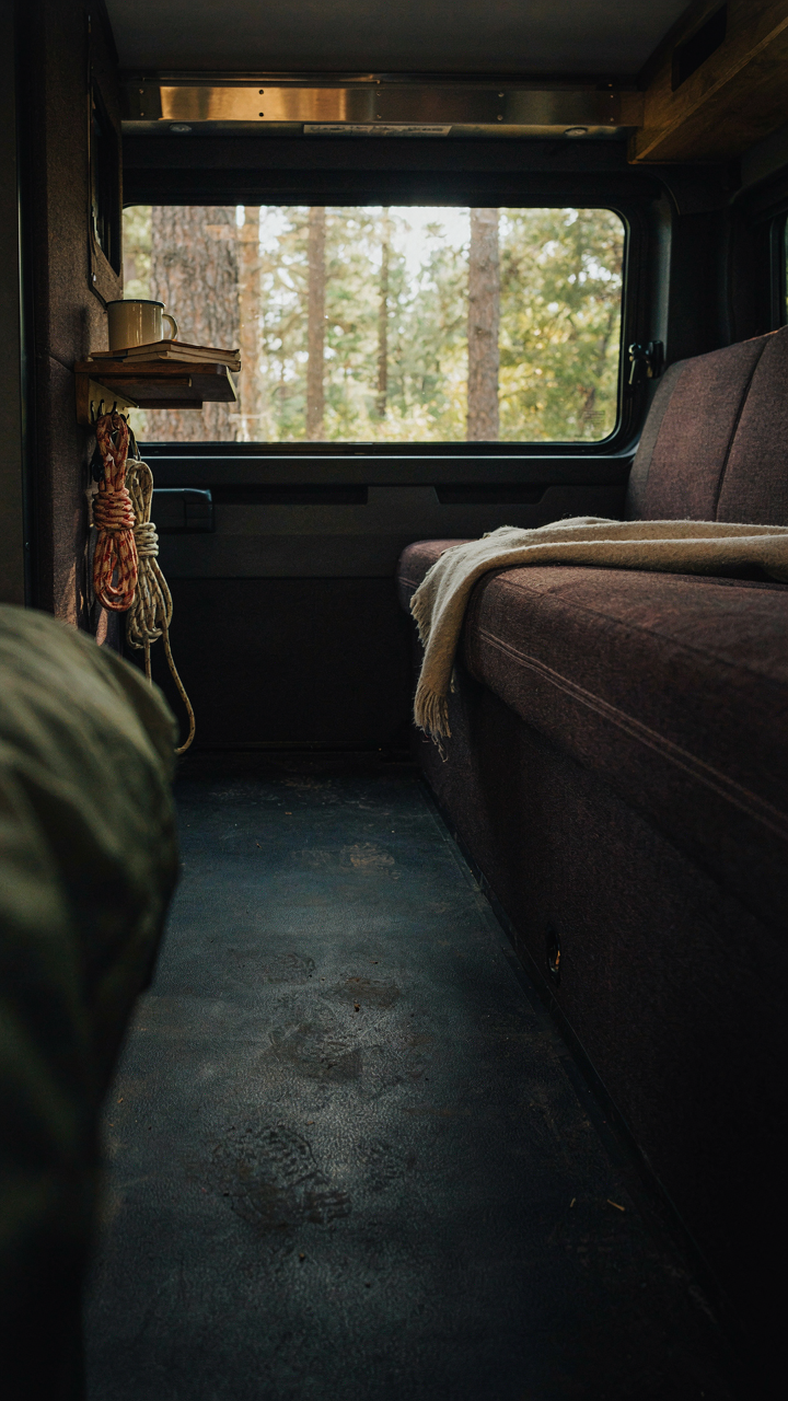 A durable RV interior with dark, textured fabrics and robust finishes, built to last.