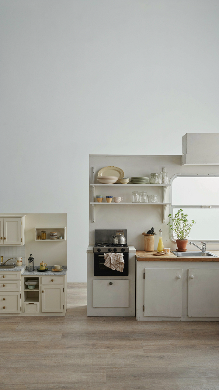 A tiny dollhouse kitchen next to a small bus conversion kitchen.