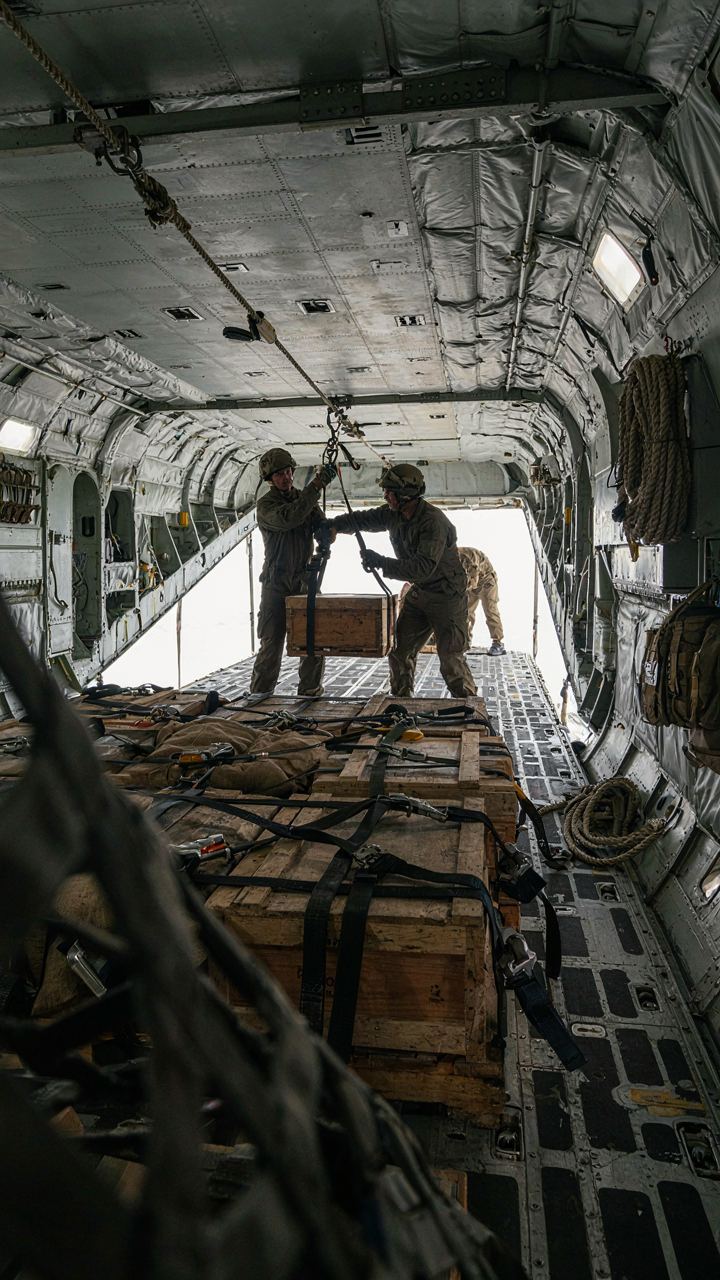 A military cargo plane interior with neatly stacked equipment.