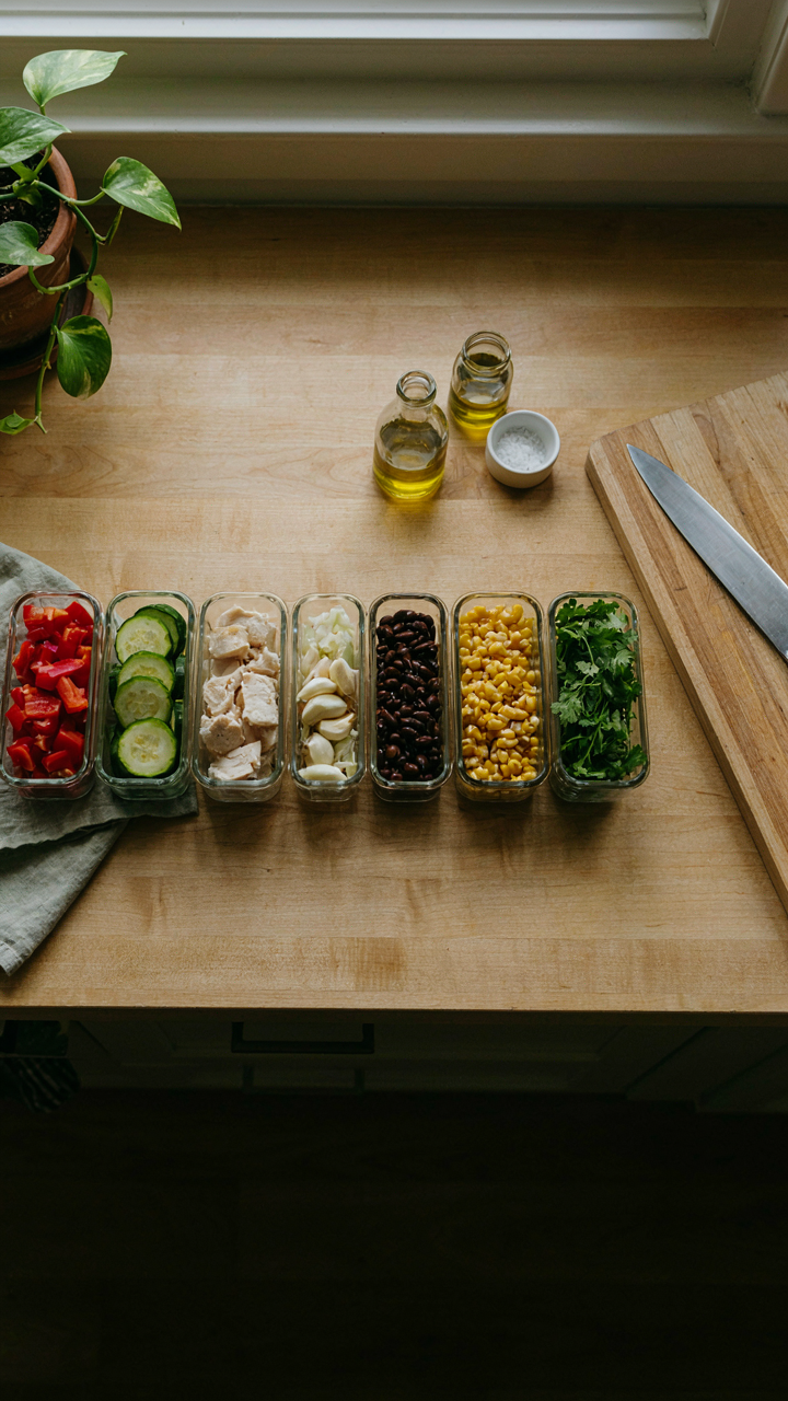 Pre-portioned ingredients for foil packet camping meals are ready on a counter.