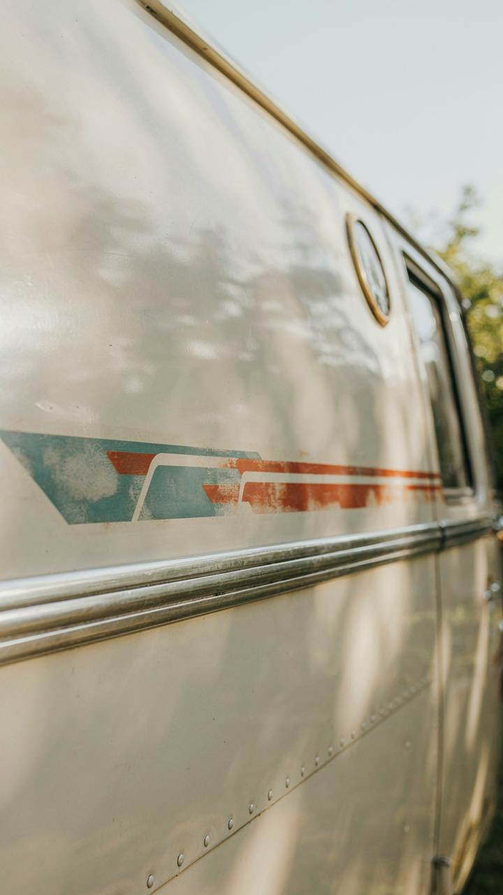 An authentic vintage decal is perfectly applied on fresh camper exterior paint.