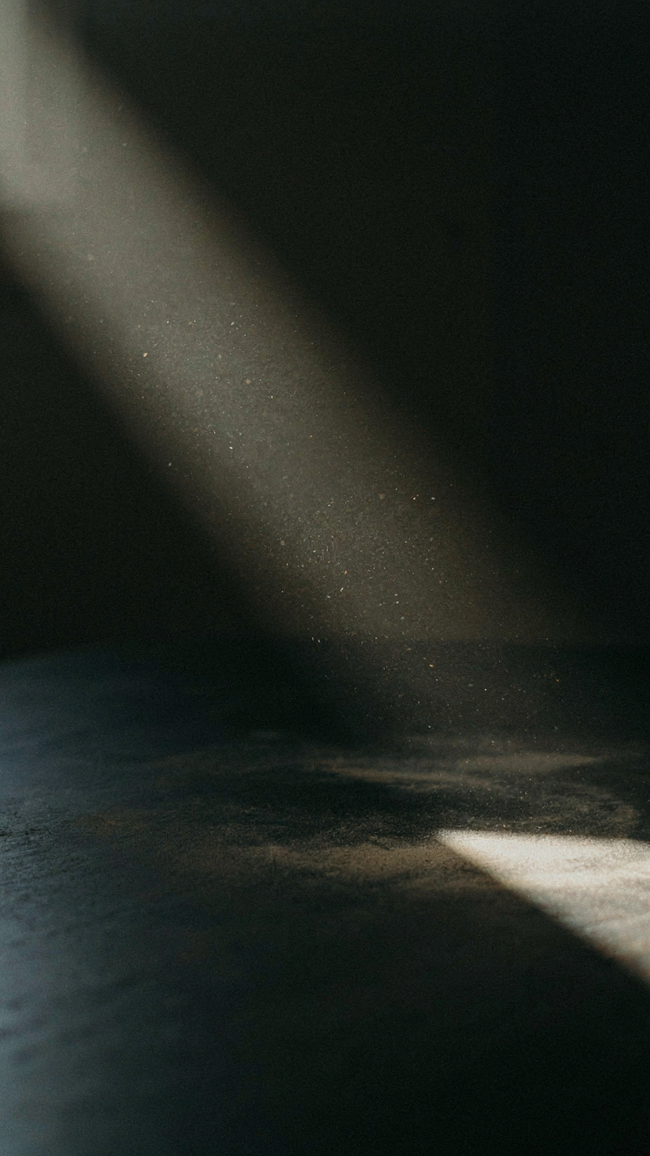 Dust settling on a dark, polished surface in an RV, highlighted by light.