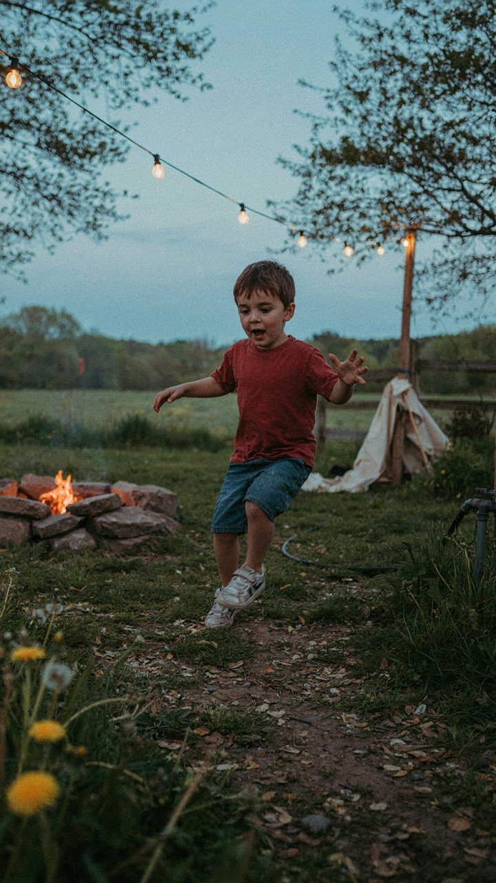 A child trips over a garden hose in a dim backyard.