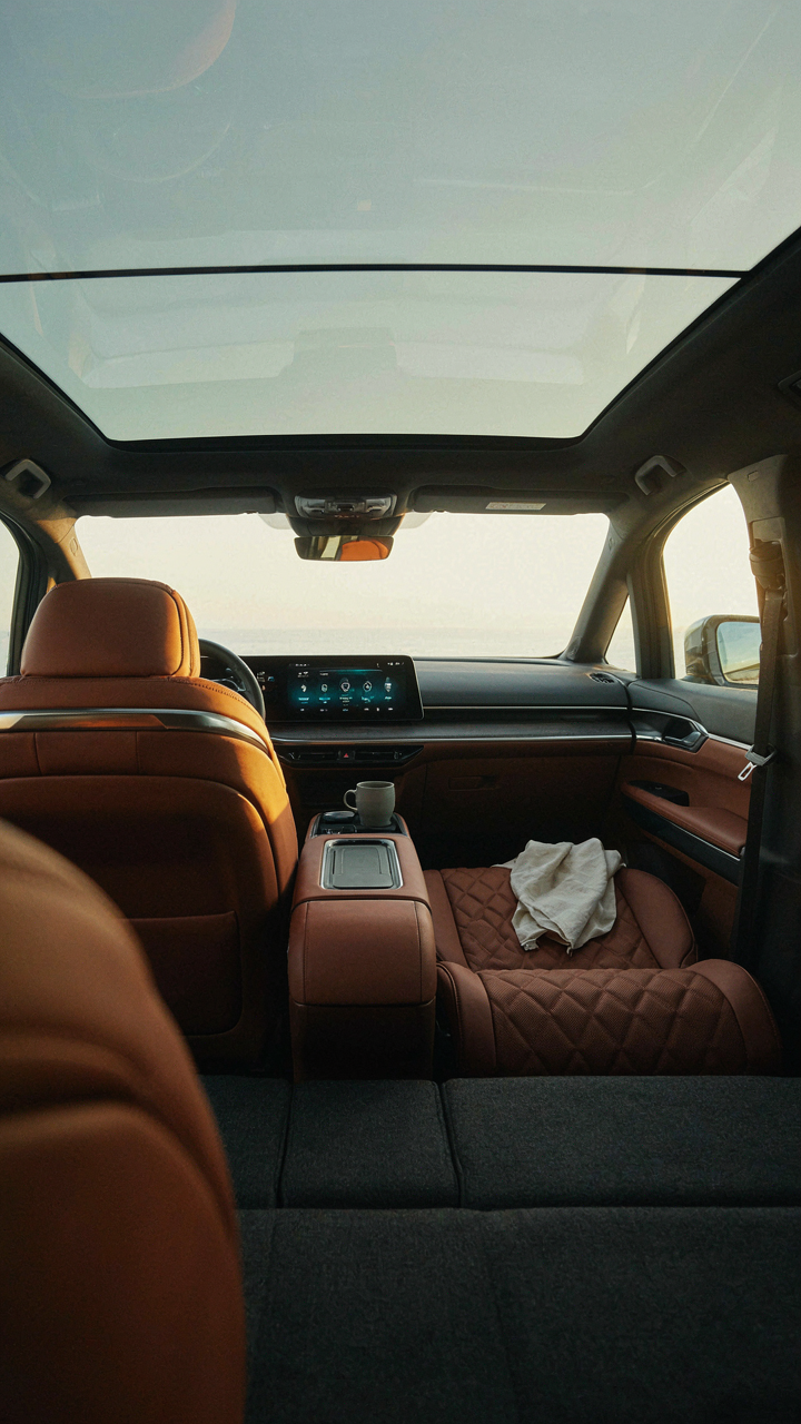 A futuristic van interior with smart climate control screens.