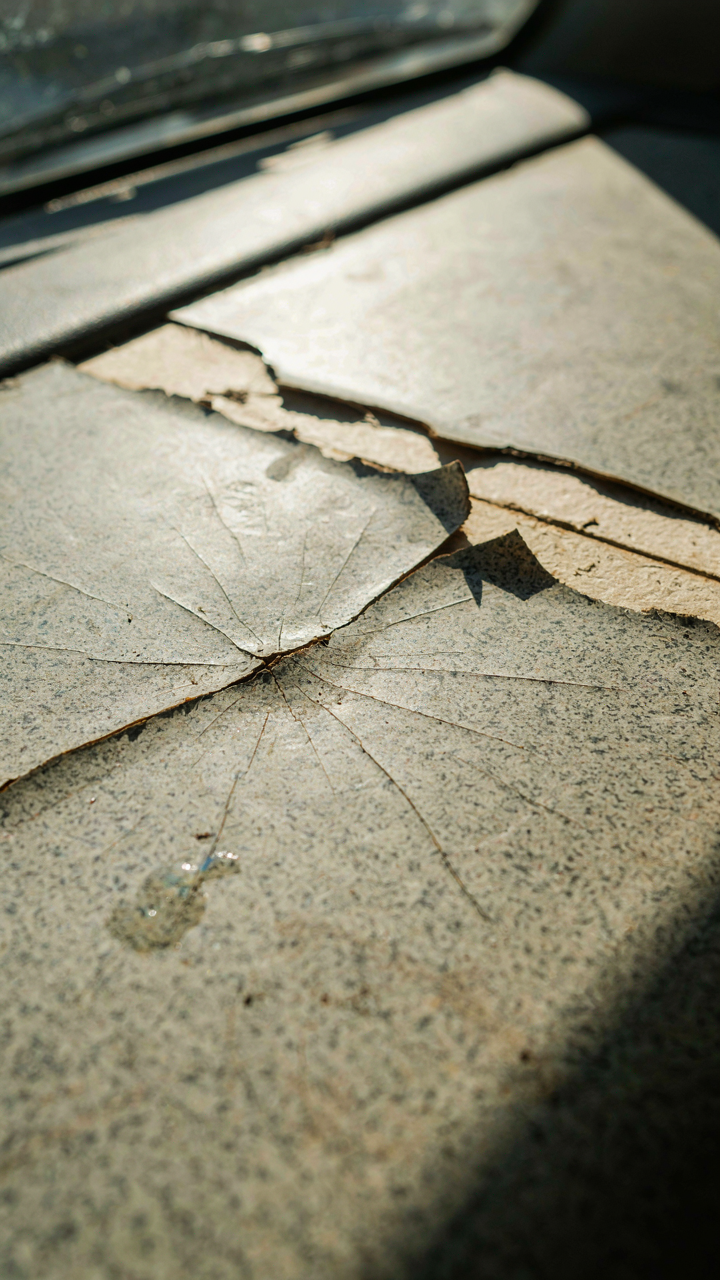 Cracked and peeling counter laminate in a hot, vibrating van interior.