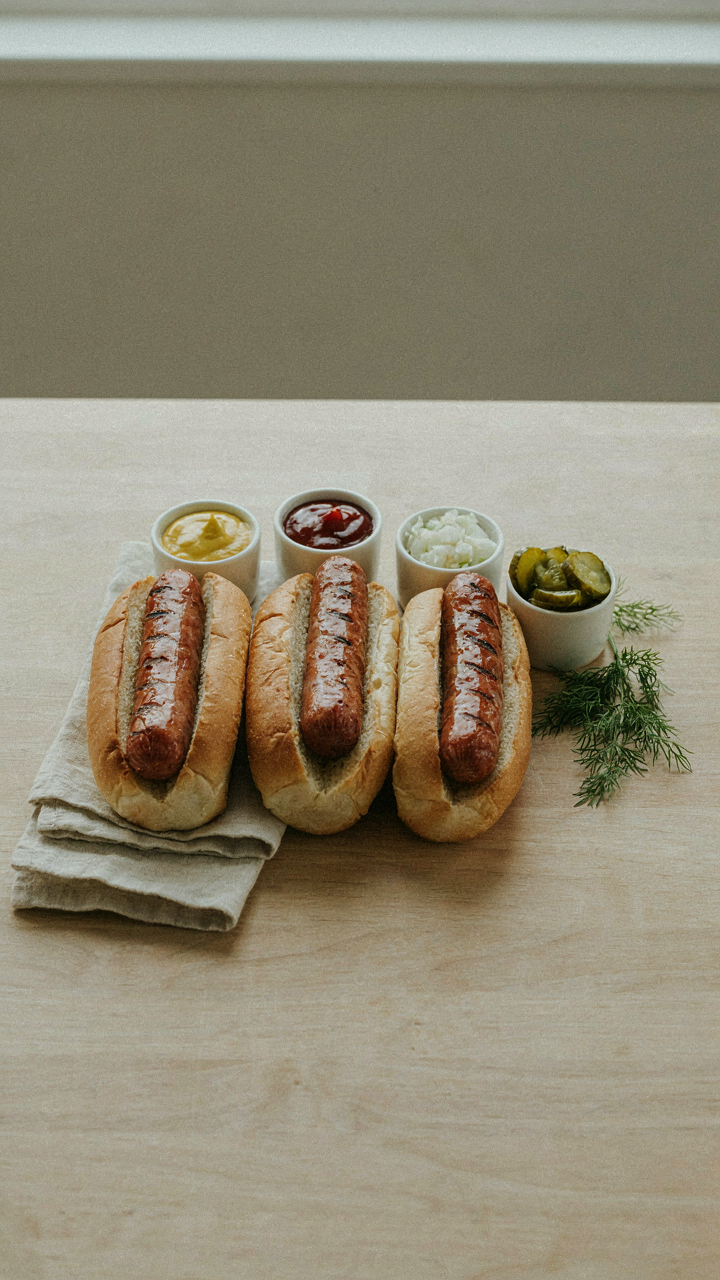 A simple and minimalist hot dog bar with a few essential condiments.