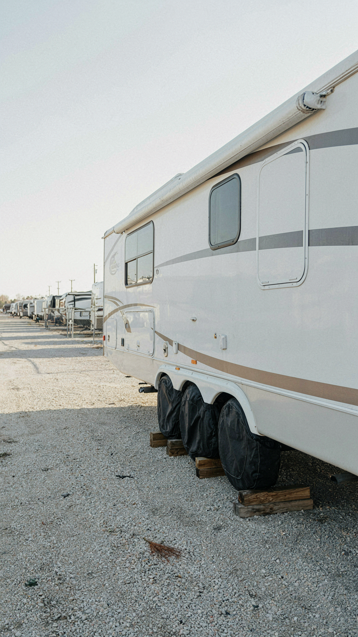 RV tires are covered and rest on leveling blocks for storage.