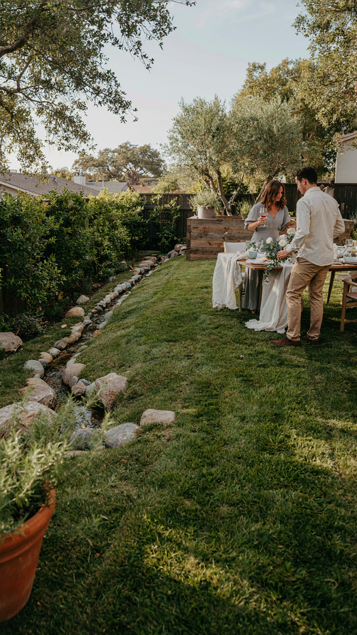 A backyard shows sloped ground and trenches to direct water away from a party.