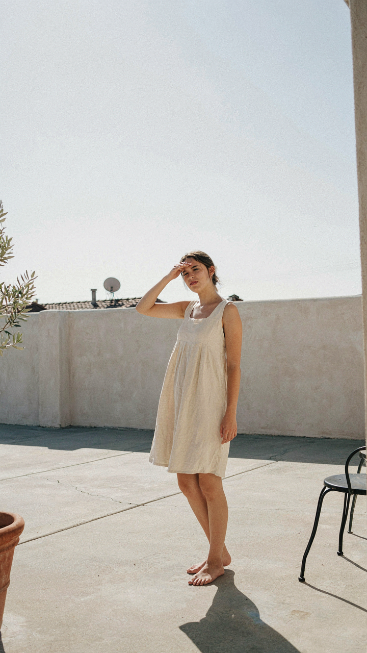 A person squints on an open patio with no shade or privacy.