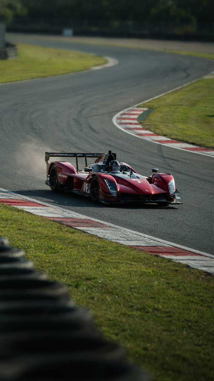 A high-performance race car cornering sharply on a track.